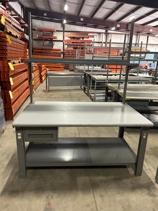 Grey office desk with book shelf