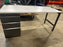 Grey office desk with book shelf